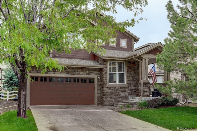 24686 E Florida Ave, Aurora, CO 80018 - view of front of home featuring stone siding, driveway, and an attached garage