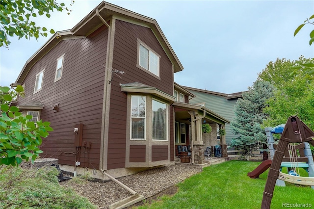 24686 E Florida Ave, Aurora, CO 80018 - view of side of home featuring a yard and a playground