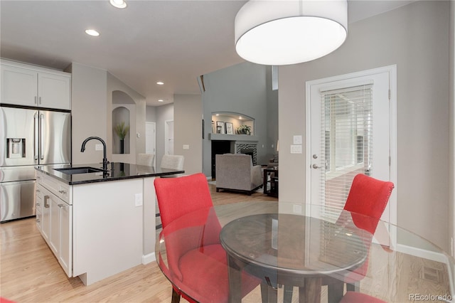 24686 E Florida Ave, Aurora, CO 80018 - dining area with light wood finished floors, recessed lighting, arched walkways, and baseboards