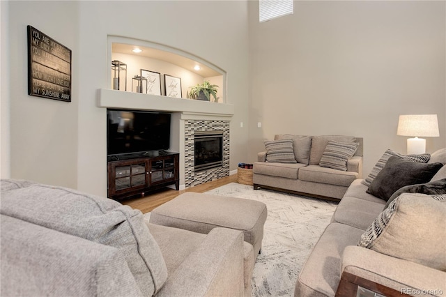 24686 E Florida Ave, Aurora, CO 80018 - living area featuring a fireplace, wood finished floors, and a high ceiling