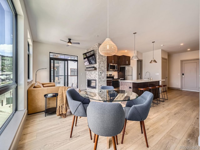 75 W 4th St Unit 205W, Silverthorne, CO 80498 - living area featuring light wood-style flooring, a fireplace, ceiling fan, and recessed lighting