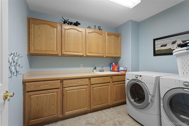 clothes washing area with cabinet space, separate washer and dryer, and light tile patterned floors