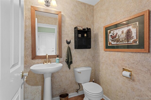 half bathroom with toilet and a sink