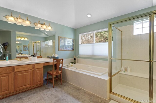 full bathroom featuring plenty of natural light, a garden tub, a shower stall, and vanity