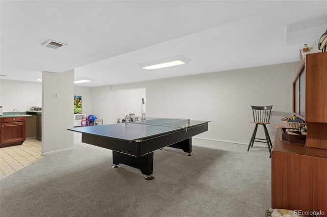 rec room with light colored carpet and baseboards