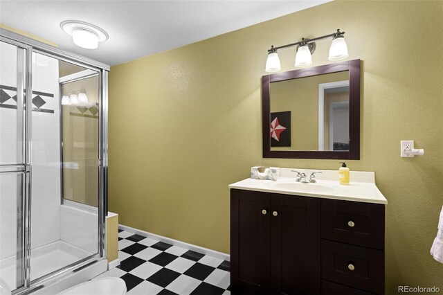 full bathroom featuring tile patterned floors, a stall shower, and vanity