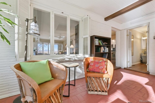 living area featuring beam ceiling