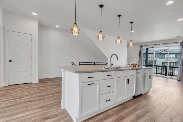 2108 Alcott Way, Broomfield, CO 80023 - kitchen with light wood finished floors, white cabinetry, hanging light fixtures, recessed lighting, and a center island with sink