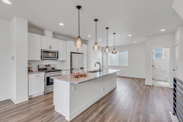 2108 Alcott Way, Broomfield, CO 80023 - kitchen with appliances with stainless steel finishes, light wood-type flooring, light countertops, white cabinets, and recessed lighting