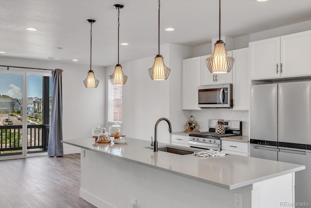 2108 Alcott Way, Broomfield, CO 80023 - kitchen with appliances with stainless steel finishes, wood finished floors, white cabinets, recessed lighting, and light countertops