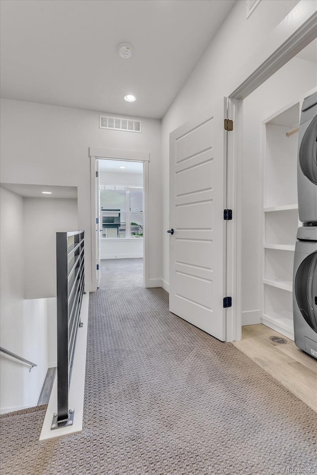 2108 Alcott Way, Broomfield, CO 80023 - hallway with stacked washer and clothes dryer, carpet floors, and recessed lighting