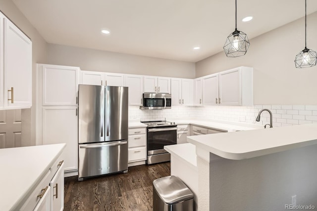 1539 Bennet Mountain Rd, Castle Rock, CO 80109 - kitchen featuring appliances with stainless steel finishes, a peninsula, white cabinetry, backsplash, and dark wood-style floors