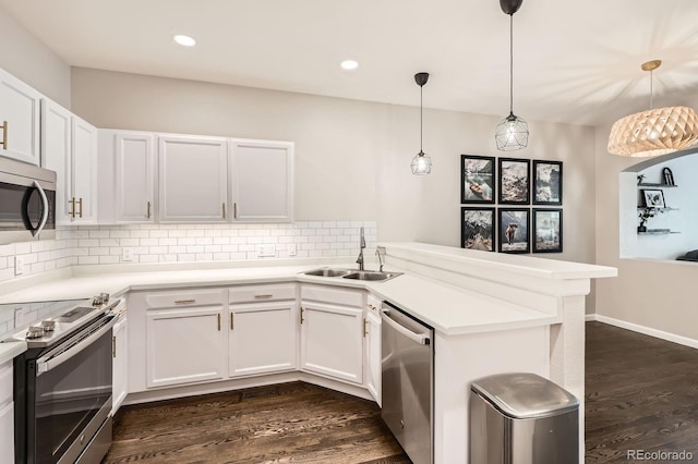 1539 Bennet Mountain Rd, Castle Rock, CO 80109 - kitchen featuring a sink, appliances with stainless steel finishes, a peninsula, backsplash, and white cabinetry
