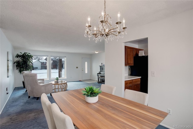 dining space with light colored carpet and a textured ceiling