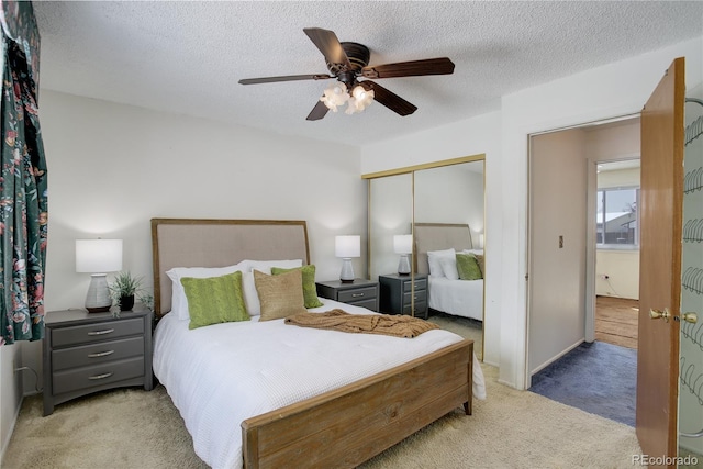 bedroom with carpet flooring, a closet, and a textured ceiling