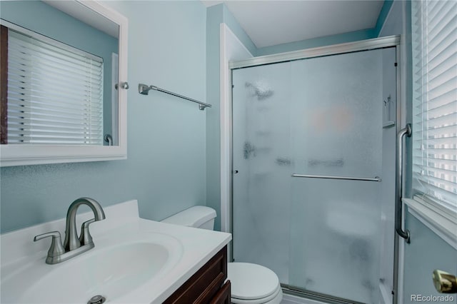 bathroom with vanity, toilet, and walk in shower