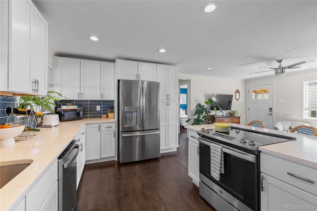 kitchen featuring appliances with stainless steel finishes, light countertops, white cabinets, and recessed lighting