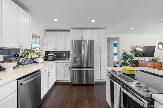 kitchen with stainless steel appliances, dark wood-style floors, light countertops, white cabinets, and recessed lighting