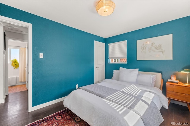 bedroom with wood finished floors and baseboards