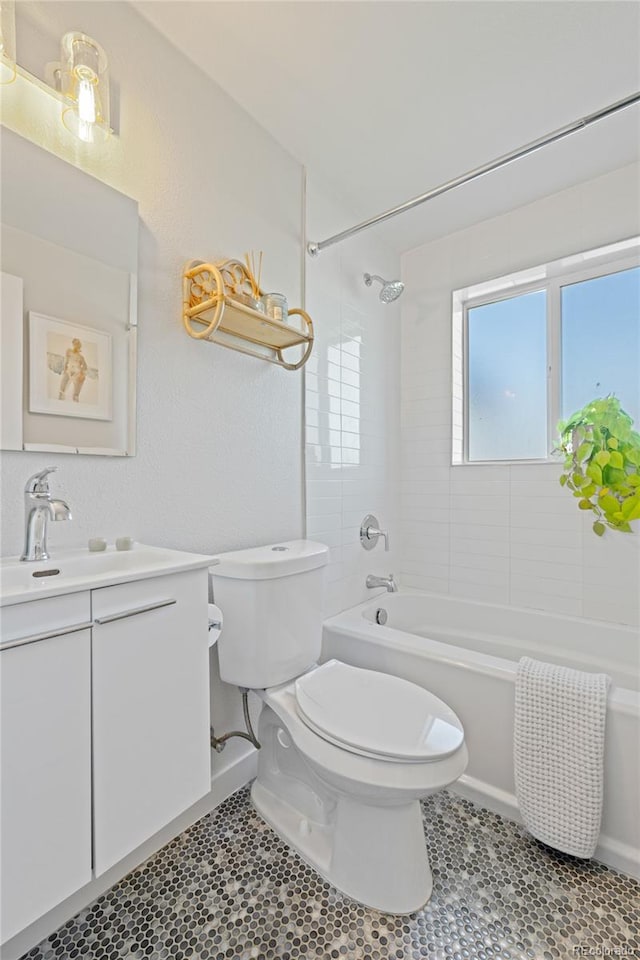full bathroom featuring toilet, vanity, tub / shower combination, and baseboards