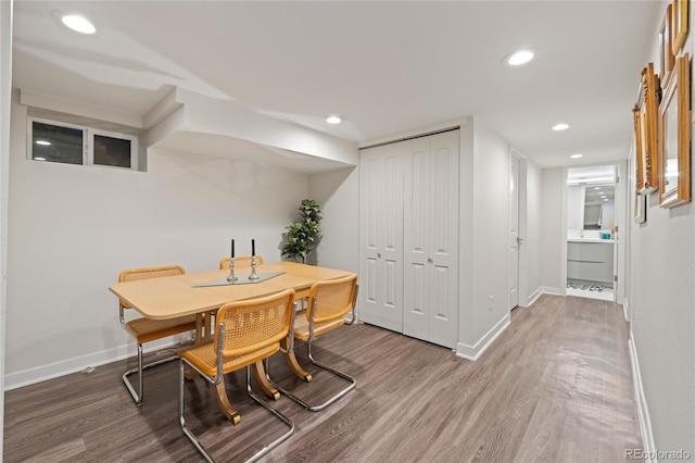 dining room featuring wood finished floors, baseboards, and recessed lighting