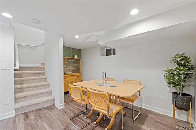 dining area with stairs, wood finished floors, baseboards, and recessed lighting