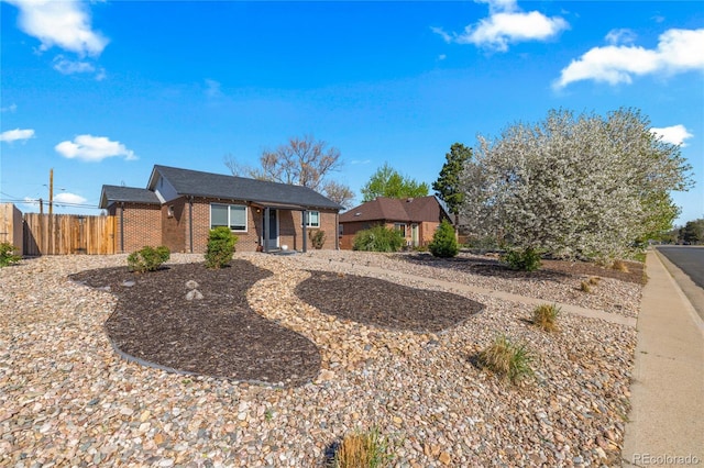 single story home with brick siding and fence