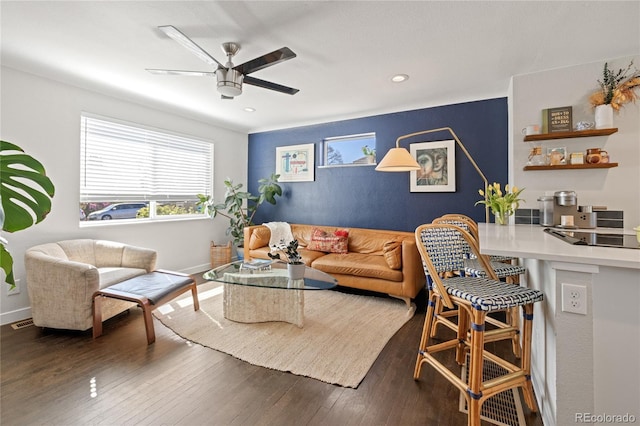 living room featuring a ceiling fan, recessed lighting, baseboards, and wood finished floors
