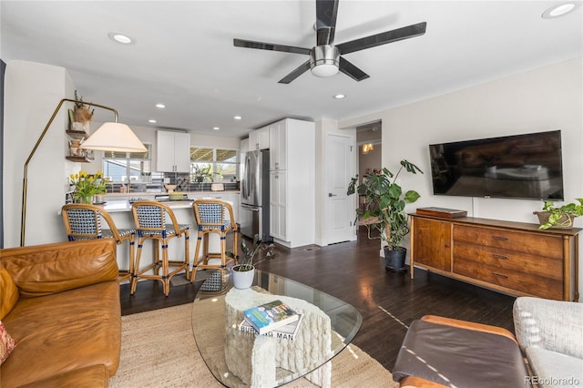 living area featuring wood finished floors, ceiling fan, and recessed lighting