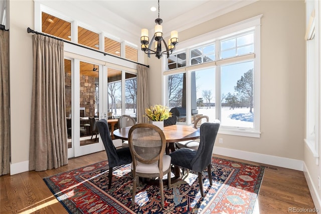 dining room with french doors, dark wood-type flooring, and a notable chandelier