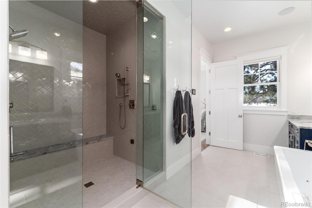 bathroom with shower with separate bathtub, vanity, and tile patterned floors