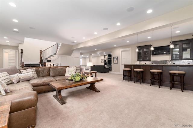 carpeted living room featuring bar