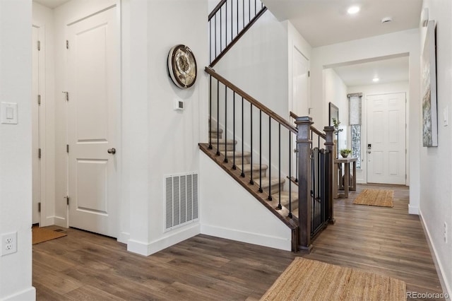 entryway with visible vents, wood finished floors, recessed lighting, stairway, and baseboards