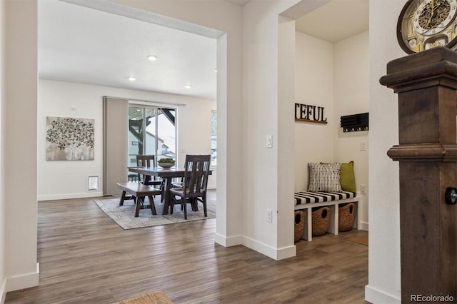 corridor featuring recessed lighting, wood finished floors, and baseboards