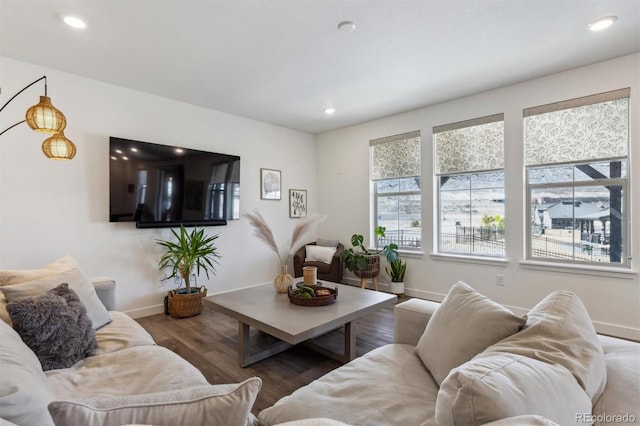 living room featuring recessed lighting, baseboards, and wood finished floors