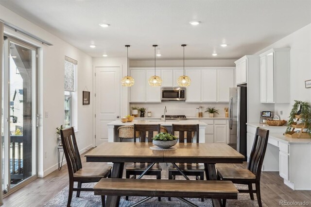 dining area with recessed lighting, baseboards, and light wood-style floors