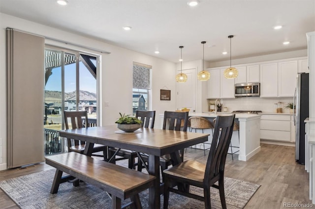 dining area with recessed lighting and light wood-style floors