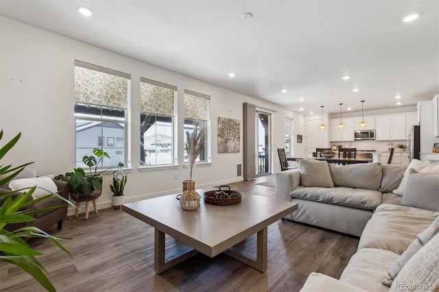 living room featuring recessed lighting, baseboards, and dark wood-style floors