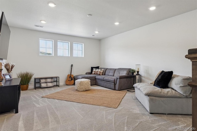 living area with recessed lighting, visible vents, and carpet flooring