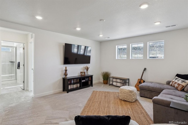 living room with recessed lighting, light colored carpet, visible vents, and baseboards