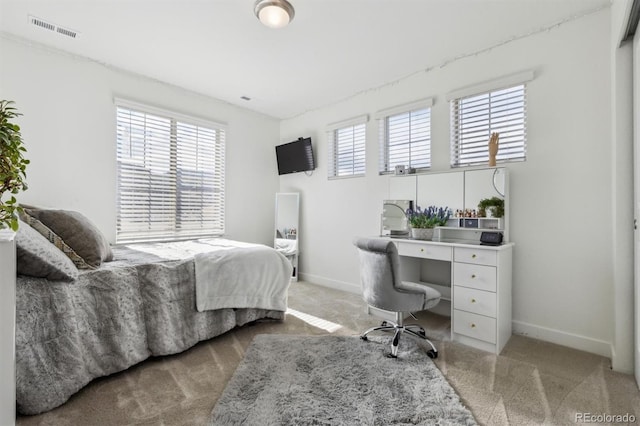 bedroom with visible vents, baseboards, and carpet