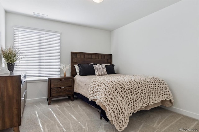 bedroom featuring visible vents, carpet floors, and baseboards