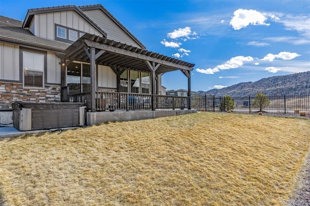 exterior space with a mountain view, a pergola, and fence