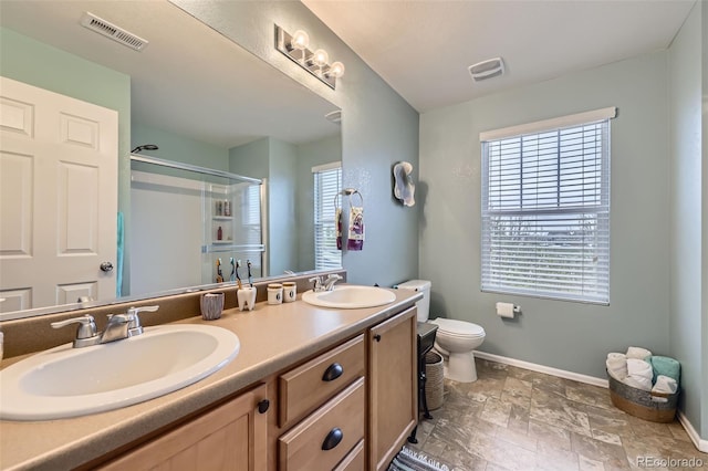 277 Jewel St, Brighton, CO 80603 - bathroom with baseboards, visible vents, a sink, and a stall shower