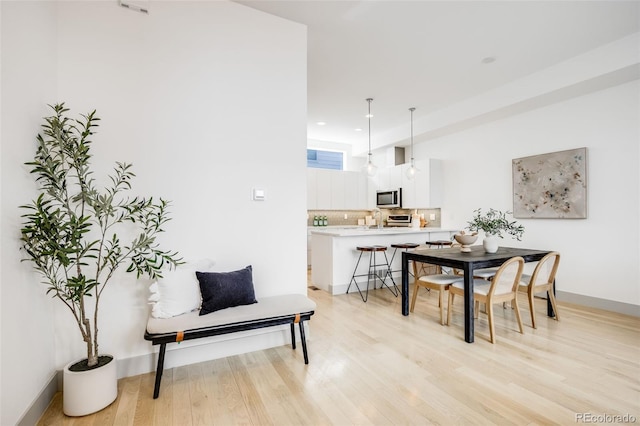 3008 Blake St, Denver, CO 80205 - dining space featuring light wood-style flooring and baseboards