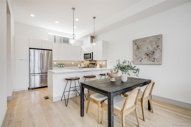 3008 Blake St, Denver, CO 80205 - dining space featuring light wood finished floors and recessed lighting