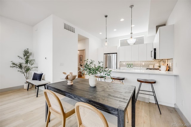 3008 Blake St, Denver, CO 80205 - dining room with light wood-style floors and recessed lighting