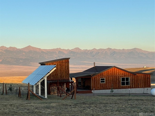 back house at dusk featuring a mountain view