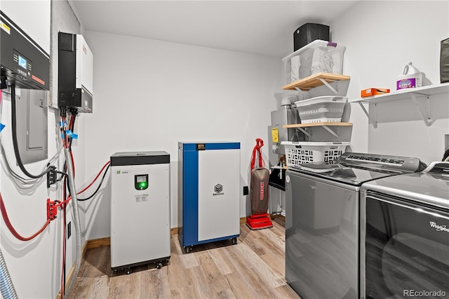 laundry room with independent washer and dryer and light hardwood / wood-style floors