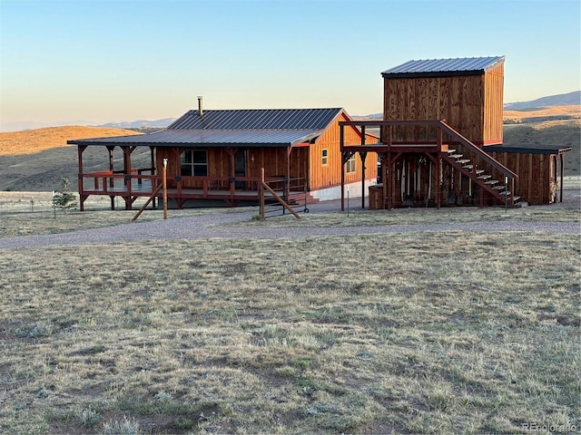 back house at dusk featuring a mountain view